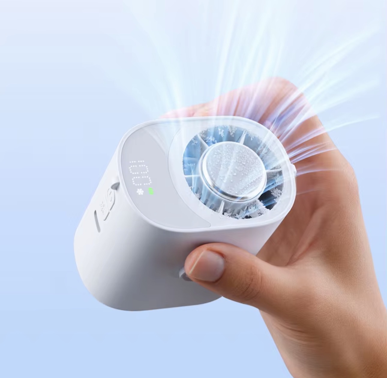 Hand holding a compact personal cooling fan